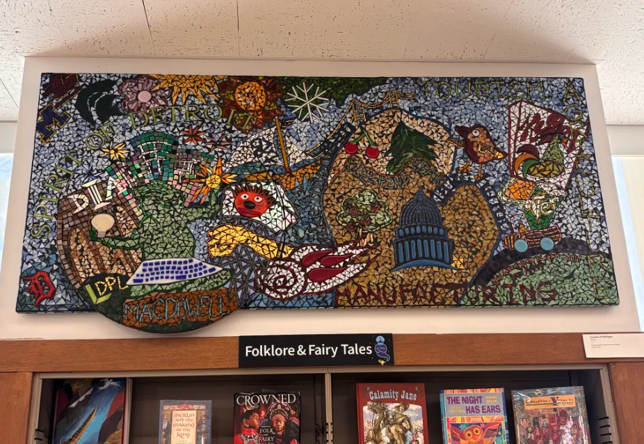 a colorful mosaic above a bookshelf
